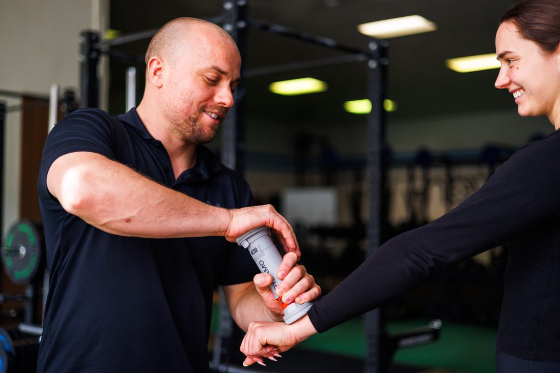 Physiotherapist treating a client on the gym floor at Game Changer Physiotherapy, Osborne Park